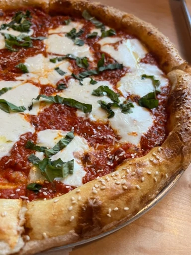 Wood Street style pizza with tomato sauce, mozzarella, and basil.